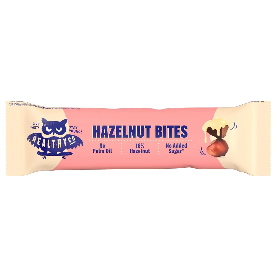 Healthyco Hazelnut Bites 21 g chokladbit i en rosa och ljusbeige förpackning med mörkblå text.