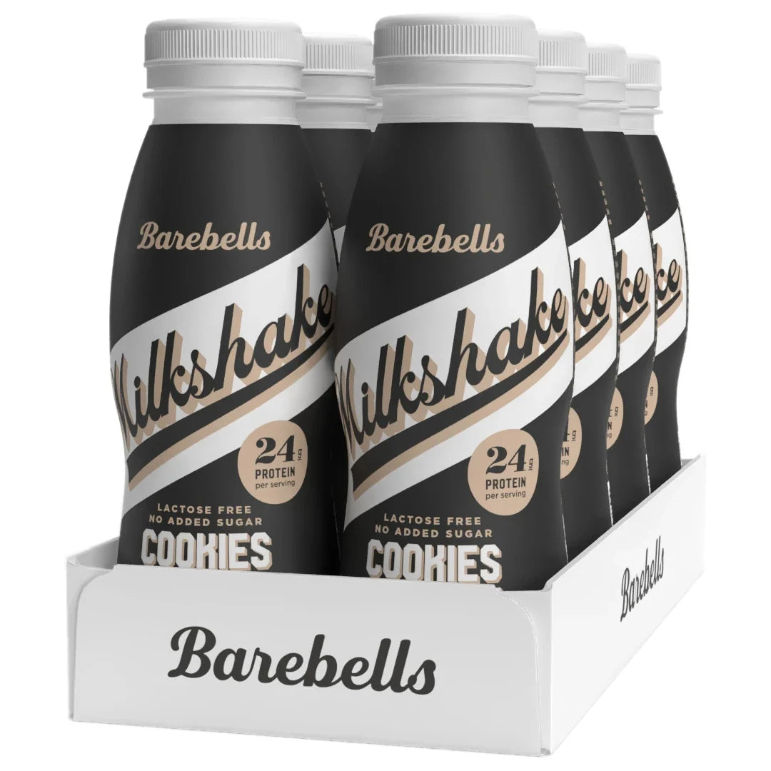 8 x Barebells Milkshake 330 ml Cookies & Cream i ett vitt flak med svarta flaskor och vita detaljer.