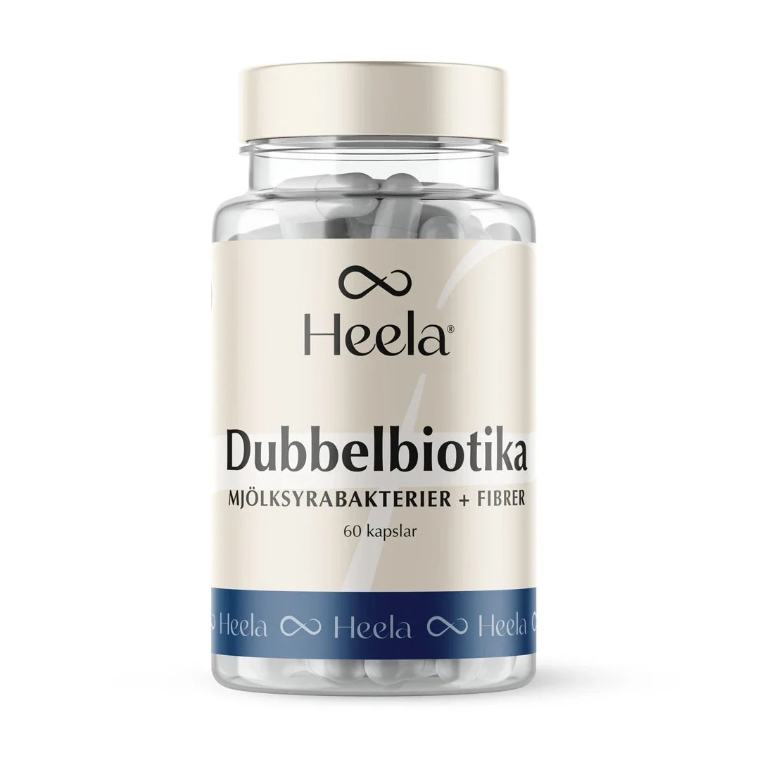 Heela Dubbelbiotika 60 caps i en genomskinlig burk med beige etikett, blåa detaljer och vita kapslar inuti.